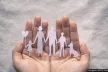 hand holding family made of paper