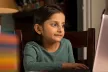 Child using a laptop in the home