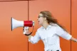 Teenage girl shouting into a megaphone