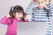Children watching a screen with surprise