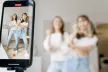 Two girls dancing on a video capture on a mobile device