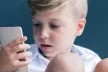 Young boy looking at a mobile device