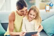 Smiling parent and child, using a tablet together