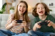 A boy and a girl holding controllers and playing videogames.