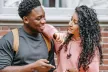 Two older teens chatting over a mobile phone