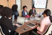 A group of black women in a conference room having a meeting