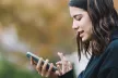 Teenage girl using a mobile device in an outside setting