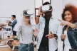 A group of three young people using VR headsets