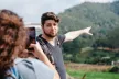Teenagers taking photos on a mobile device in the countryside