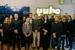 Crowd of people standing with 'Yubo' in the background