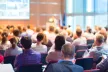 A bird view of a conference venue filled with participants