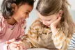 Two little girls laughing together