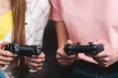 Boy and girl playing with a game console in their hand