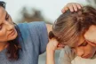A sad child consoled by his mother