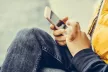 Hands of a young child tapping on a smartphone