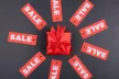 Wrapped gift surrounded by sale tags