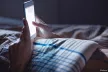 Hands holding a smartphone in the dark