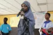 A young girl giving a speech in her classroom