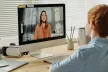 Young boy facing a desktop computer watching an online class