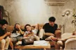 Young people on the couch, playing on their phone