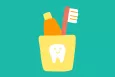 A toothbrush and toothpaste in a cup holder