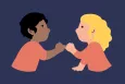 Two young people with their pinkies intertwined.