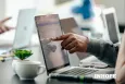 Hand pointing at a laptop screen with INHOPE logo superimposed