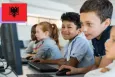 A group of five school mates looking at computer screens and using a mouse