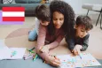 Mom playing coloring a book with her two sons