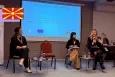 Three young people on stage during a session at the youth panel event in Skopje, North Macedonia