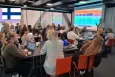 Group of experts from Nordic countries' SICs having a meeting in a large conference room