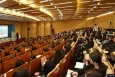 Birdview of the conference venue with lots of participants sitting in the seats
