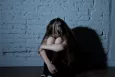 Lonely, upset child in a dark, sinister setting