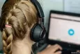 Girl with headphones watching a screen