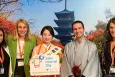 Panel of conference goers smiling at the camera on a japanese-styled background