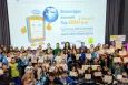 Young people and adults standing for a picture- behind them the SID logo